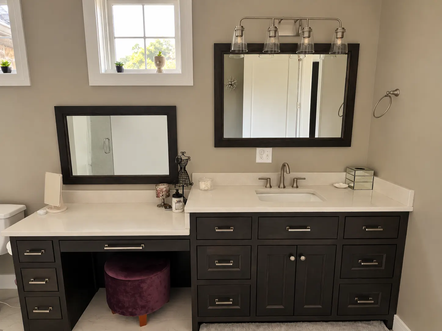Dark bathroom vanity with a makeup desk and open knee space